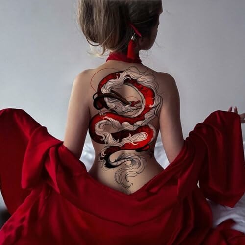 Girl with a dragon tattoo on her back, wearing a red dress.