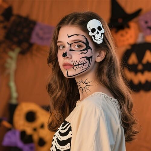 Girl with skeleton face paint and Halloween decorations