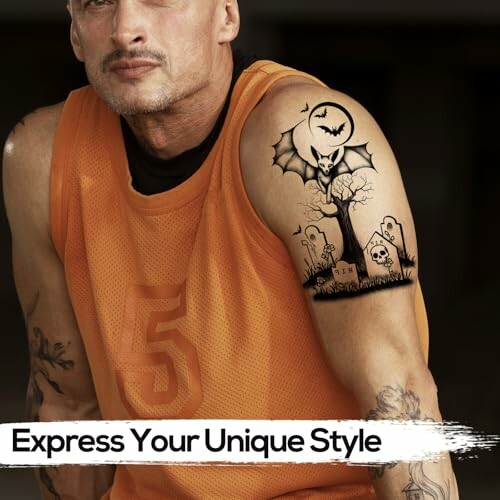 Man wearing an orange jersey with a Halloween-themed tattoo on his arm.