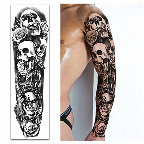 Arm tattoo featuring skulls and roses in black and white